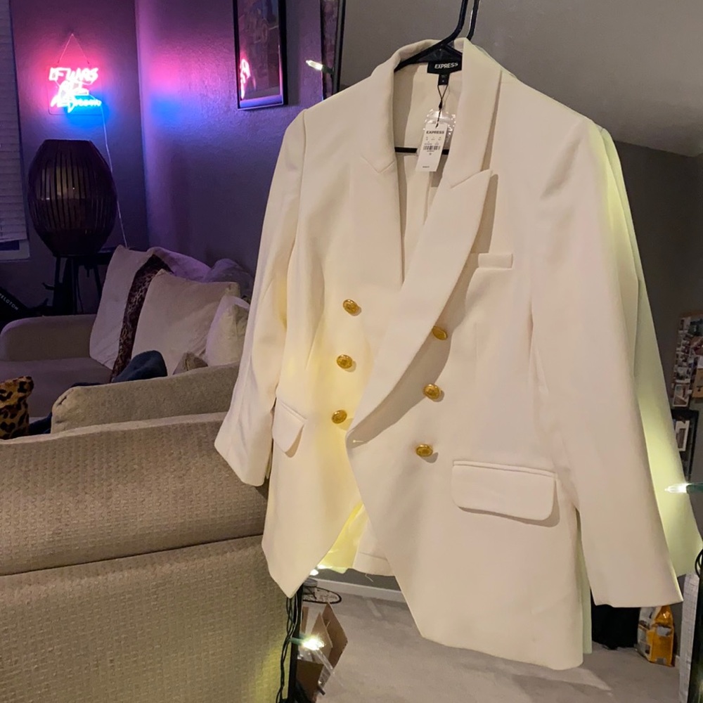 Cream/white blazer with gold buttons.